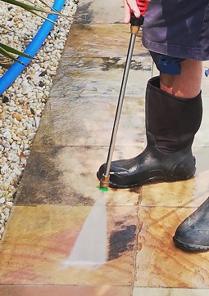 Pressure washing a sandstone paver Curlewis